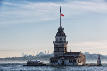 excursion tourist ship swims up to the Maiden tower in Istanbul