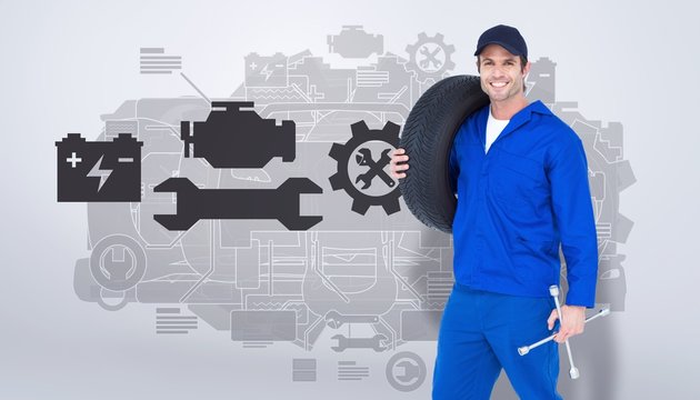 Composite image of confident mechanic carrying tire