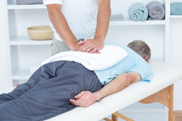 Physiotherapist doing back massage 