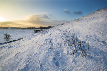 Fototapeta na wymiar Beautiful snow covered sunrise Winter rural landscape