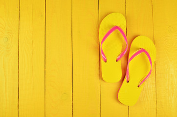Flip Flops Yellow on yellow wooden background