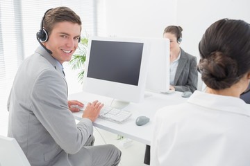 Obraz na płótnie Canvas Smiling businessman wearing headset 
