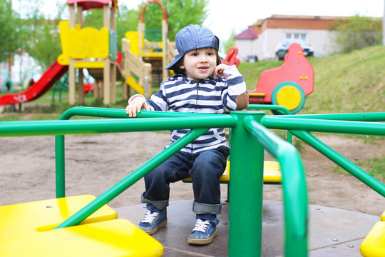 Cute little boy on merry-go-round