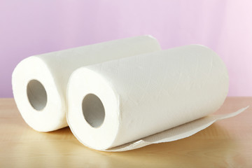Roll of paper towel on brown wooden background