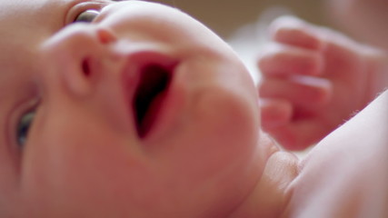 Close up of newborn baby laying on carpet
