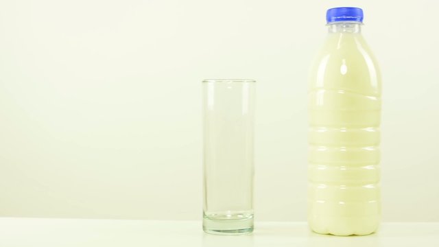 bottle of milk and glass - white background studio
