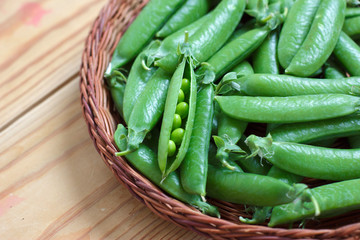 Fresh green peas in a basket