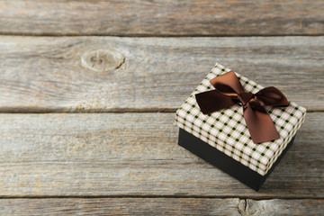 Beautiful gift box on grey wooden background