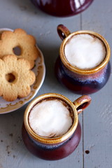 Iced coffee in brown and gray ceramic cups