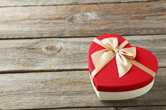 Beautiful heart gift box on grey wooden background