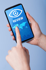 Man presses a touch screen smart phone with the symbol of  revie