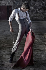 Torero dressed with campero outfit, with cape and sword in hand