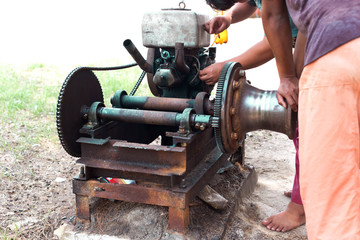 Select focus of Working men repair an engine