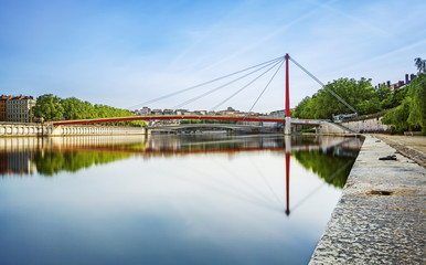 Wide red bridge over the Soane in Lyon city