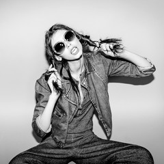 Emotional pretty young hipster girl make funny face on blue