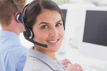 Smiling businesswoman wearing headset 