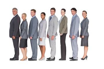 Obraz premium Business team standing in row and smiling at camera