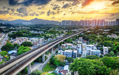 Obraz premium hong kong urban downtown and sunset speed train