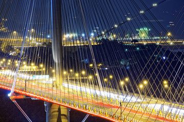 Fototapeta na wymiar highway bridge at night with traces of light traffic