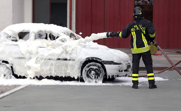 firefighters during exercise to extinguish a fire in a car