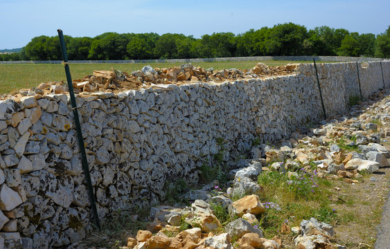 Restore drywall with stones wall in focus, countryside of Apulia