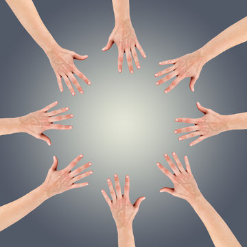 Group of eight hands at the circle together teamwork showing you