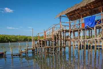 Traditional wooden house on stilts above water