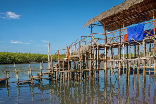 Traditional Wooden House On Stilts Above Water