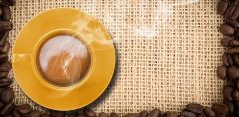 Composite image of yellow cup of coffee