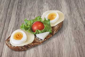 Toasted Integral Bread Sandwich On Walnut table surface.