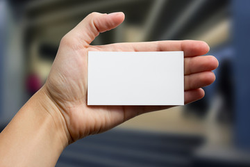 Fototapeta premium Hands holding a white business visit card, gift, ticket, pass