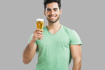 Fototapeta premium Young man drinking beer