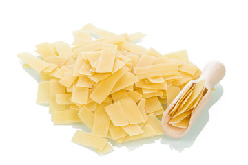 Italian uncooked pasta with wooden scoop 
