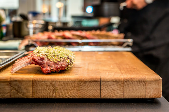 Lamb chops with pistachio coating on the surface of wood