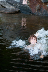 Fototapeta na wymiar young boy playing in a lake 