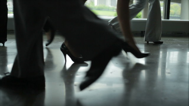 Male and female Business Professionals break and shake hands