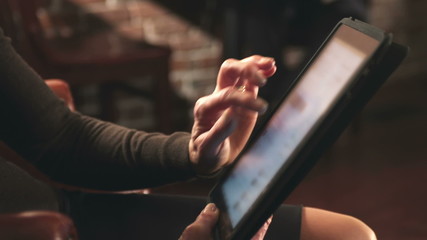 A woman is using a digital tablet - Powered by Adobe