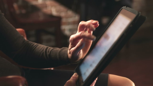 A woman is using a digital tablet