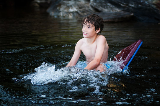 Young Boy  Floating On A Boogie Board 