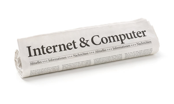 Zeitungsrolle mit der Überschrift Internet und Computer
