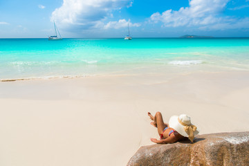 Fototapeta na wymiar Girl at beautiful beach - Anse Georgette at Praslin - Seychelles