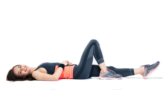 Cheerful sporty woman lying on the floor