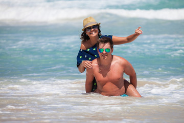 Couple have a fun in ocean's waves