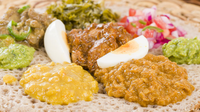 Ethiopian Feast - Injera (sourdough flatbread) with doro wat (red chicken stew), yebeg alicha (mild lamb stew), misir wat (red lentils puree), kik alicha (yellow split peas)
