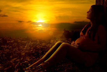 Pregnant woman at sunset