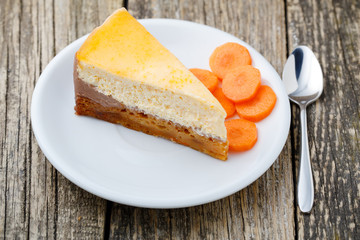 Sweet slice of carrot cake on white plate.
