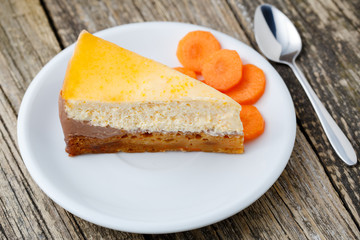 Sweet slice of carrot cake on white plate.