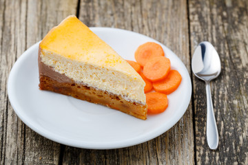 Sweet slice of carrot cake on white plate.