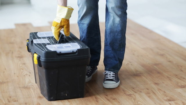 close up of man carrying tool box and leaving it