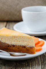 Sweet slice of carrot cake with coffee cup.